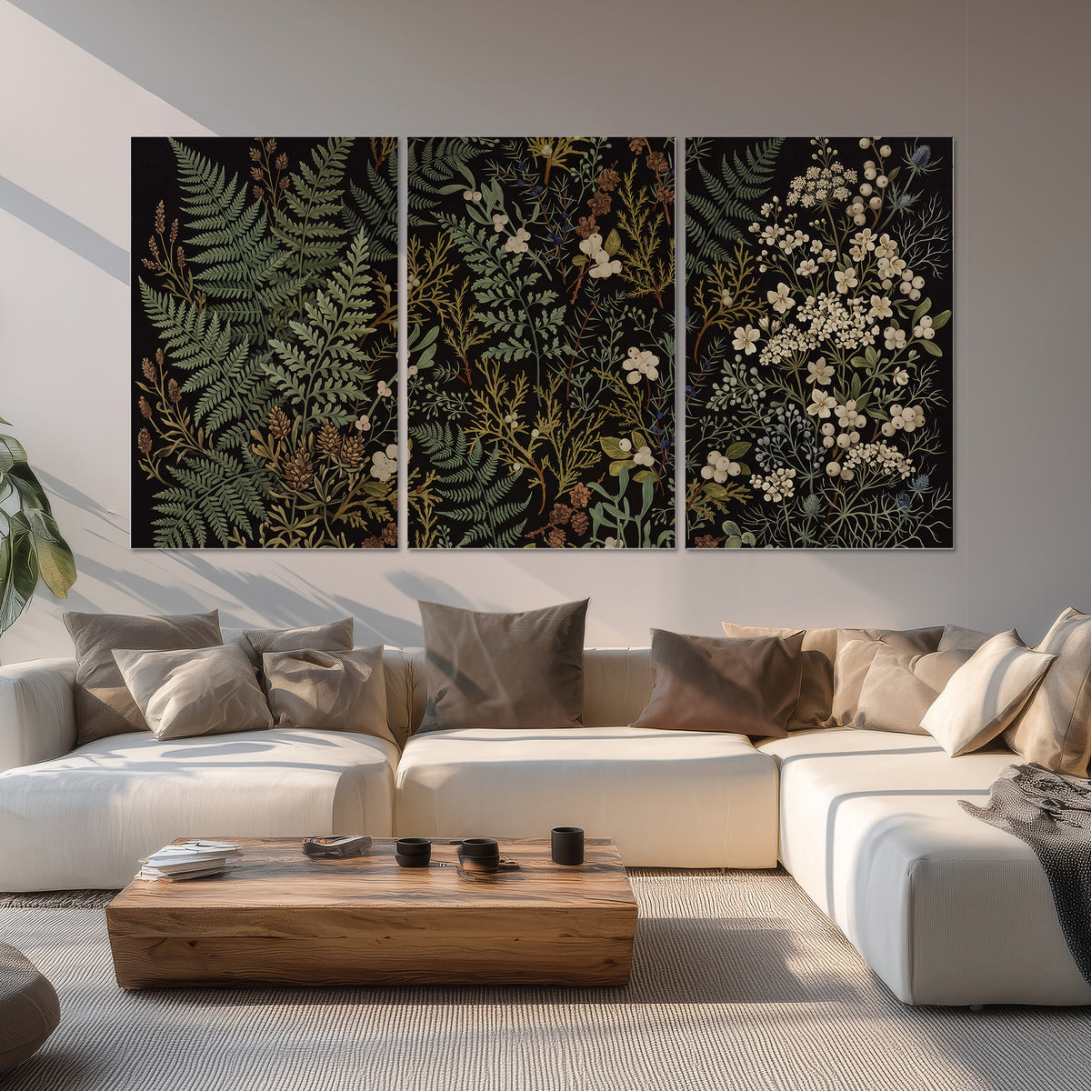 Layered green ferns and delicate cream flowers on a black background set of 3 poster prints displayed in a living room