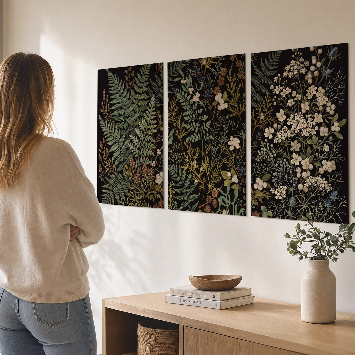 Layered green ferns and delicate cream flowers on a black background set of 3 poster prints three panel arrangement on a wall