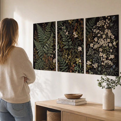 Layered green ferns and delicate cream flowers on a black background set of 3 poster prints three panel arrangement on a wall