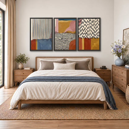 Terracotta, pink, mustard and blue shapes with black line patterns 3 piece framed canvas wall art styled in an interior