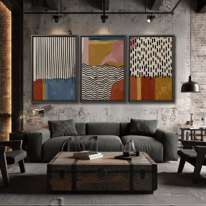 Terracotta, pink, mustard and blue shapes with black line patterns 3 piece framed canvas wall art displayed in a industrial room