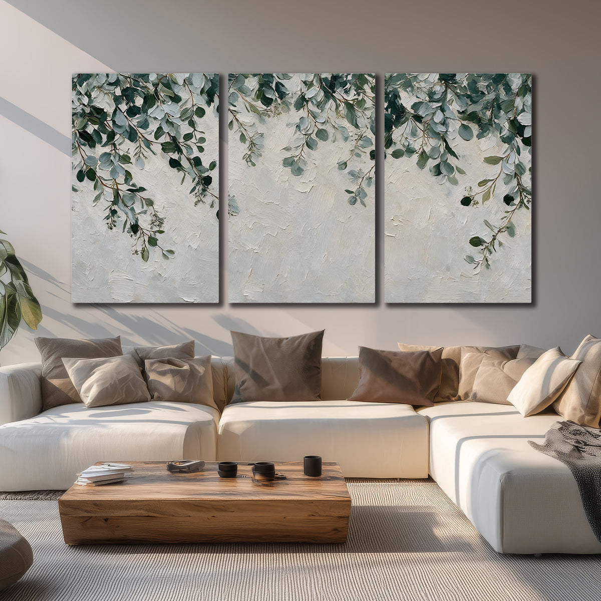 Soft green eucalyptus branches on a cream background 3 piece canvas wall art displayed in a living room
