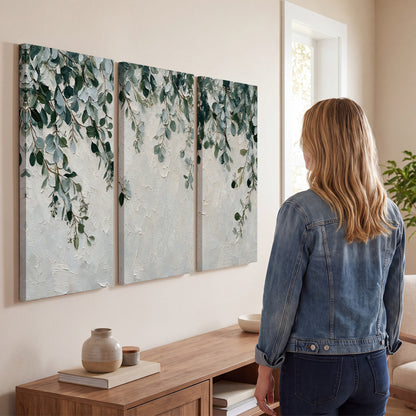 Soft green eucalyptus branches on a cream background 3 piece canvas wall art three panel arrangement on a wall
