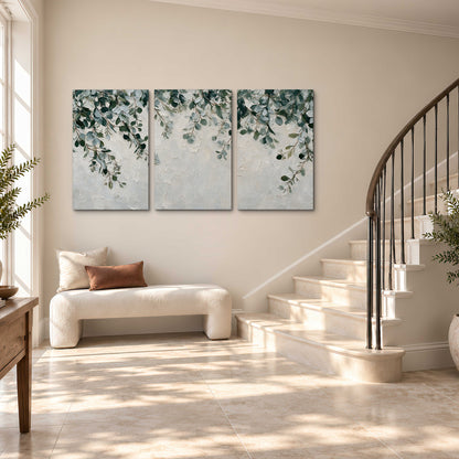 Soft green eucalyptus branches on a cream background 3 piece canvas wall art styled in an interior
