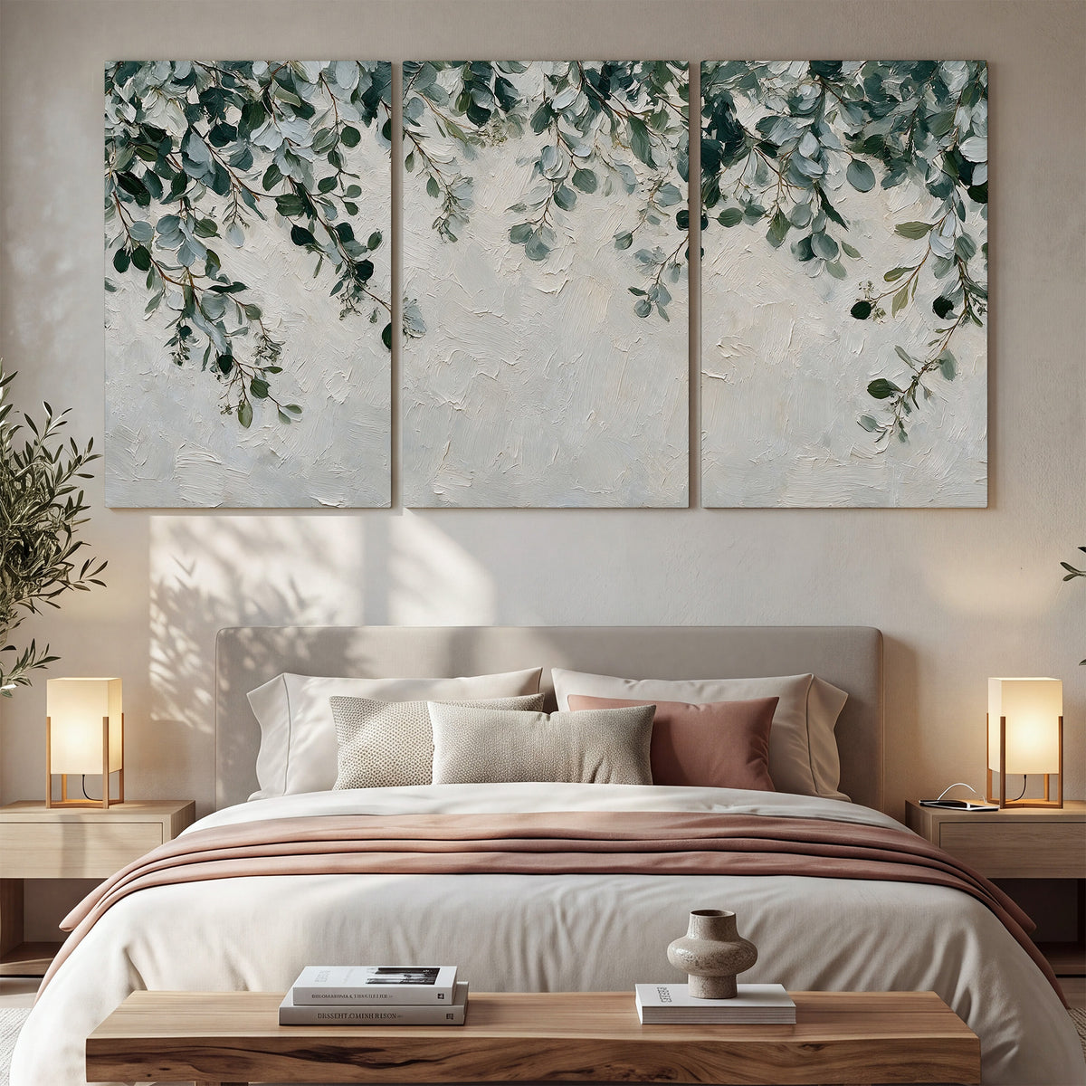 Soft green eucalyptus branches on a cream background 3 piece canvas wall art displayed in a bedroom