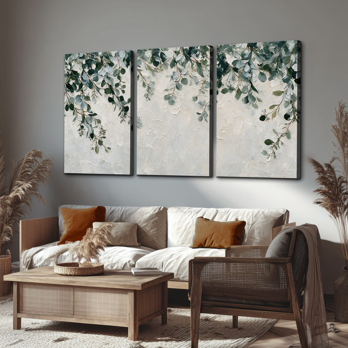 Soft green eucalyptus branches on a cream background 3 piece canvas wall art displayed in a rustic living room