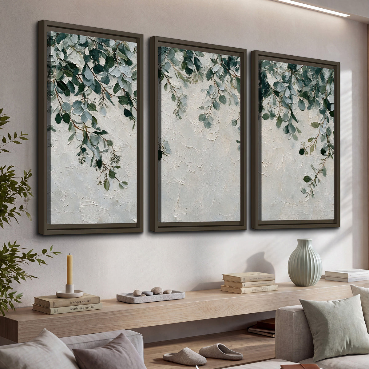 Soft green eucalyptus branches on a cream background 3 piece framed canvas wall art displayed in a console