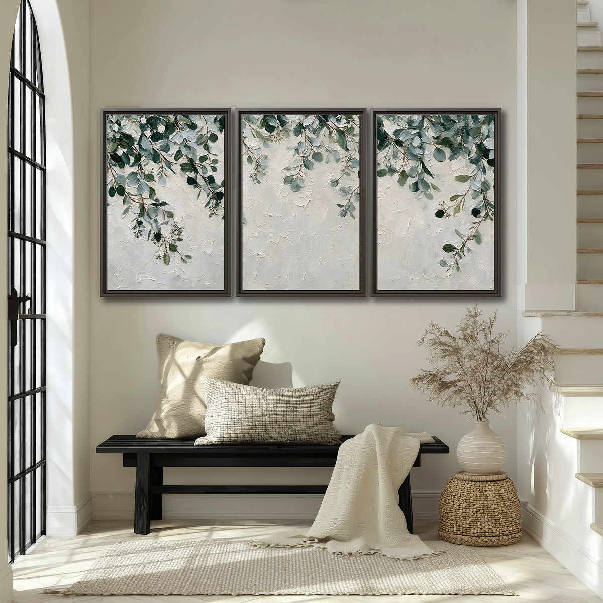 Soft green eucalyptus branches on a cream background 3 piece framed canvas wall art displayed in a entryway