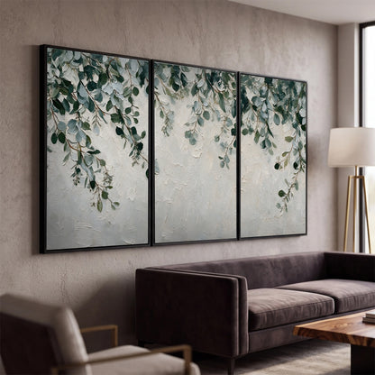 Soft green eucalyptus branches on a cream background 3 piece framed canvas wall art displayed in a modern living room