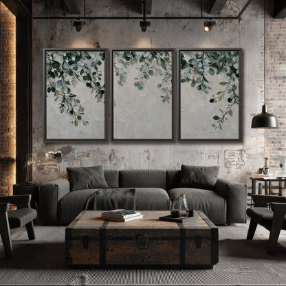 Soft green eucalyptus branches on a cream background 3 piece framed canvas wall art displayed in a industrial room