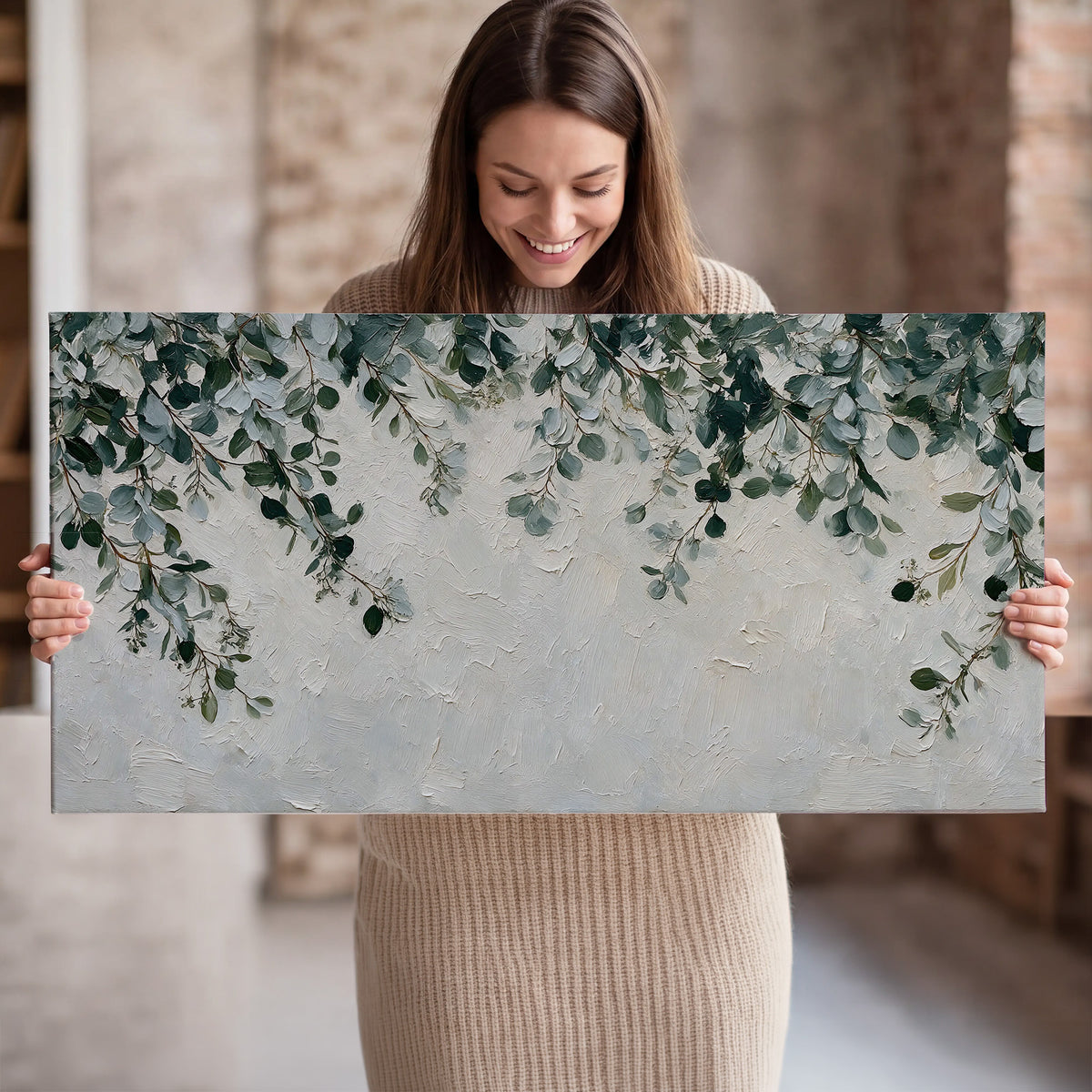 Soft green eucalyptus branches on a cream background single canvas wall art held in hands