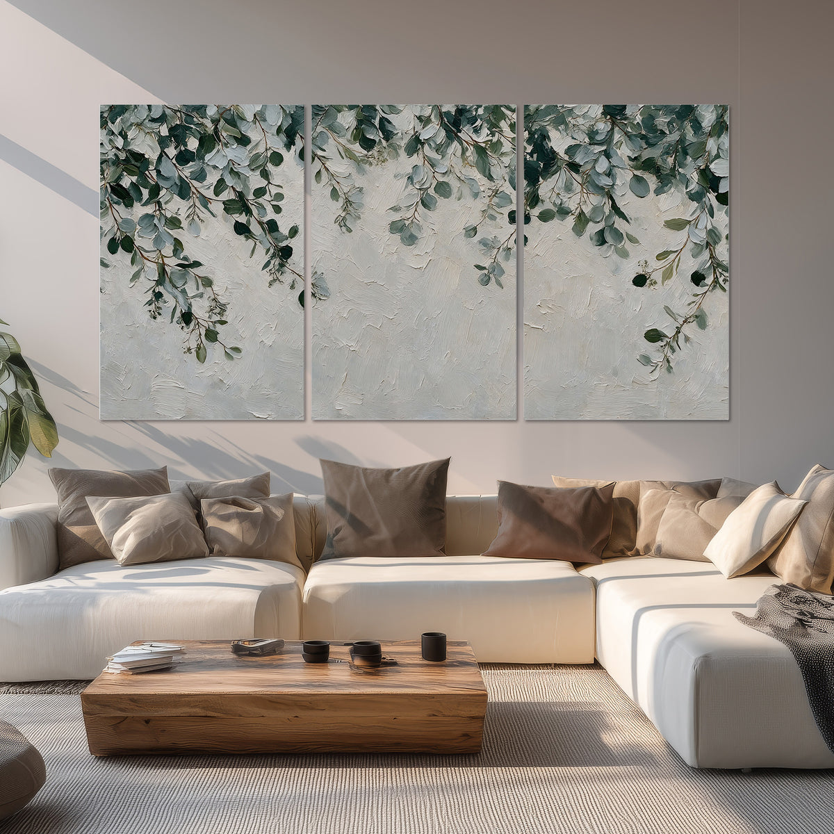 Soft green eucalyptus branches on a cream background set of 3 poster prints displayed in a living room