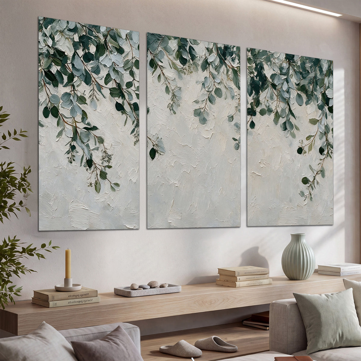 Soft green eucalyptus branches on a cream background set of 3 poster prints displayed in a console