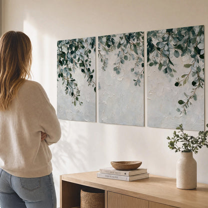 Soft green eucalyptus branches on a cream background set of 3 poster prints three panel arrangement on a wall