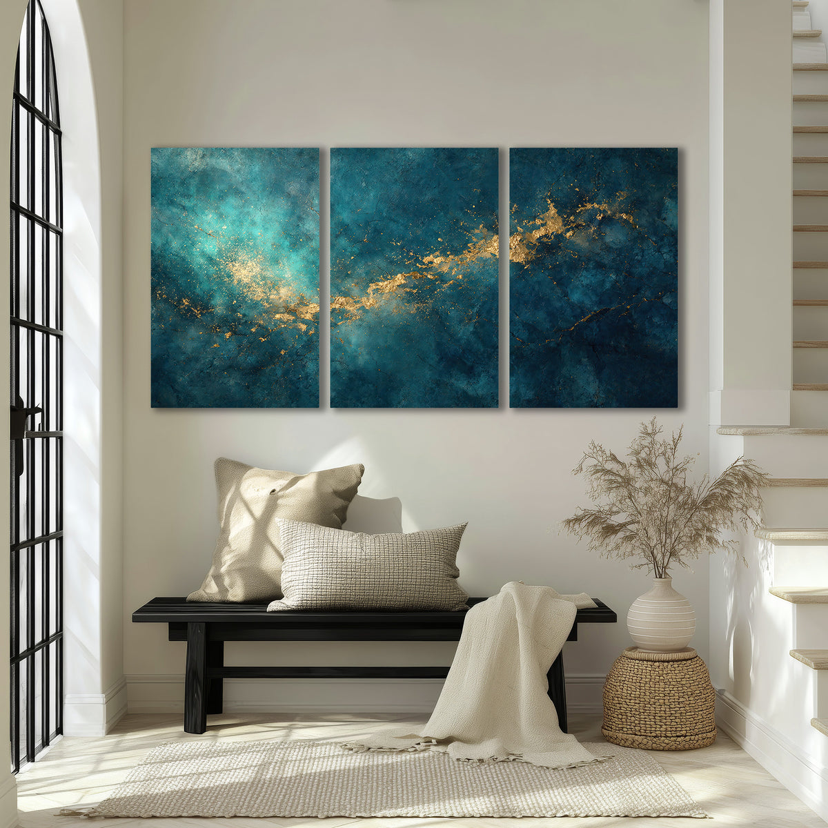 Deep teal clouds with sweeping gold-colored accents 3 piece canvas wall art displayed in a entryway