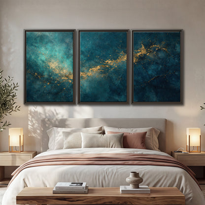 Deep teal clouds with sweeping gold-colored accents 3 piece framed canvas wall art displayed in a bedroom
