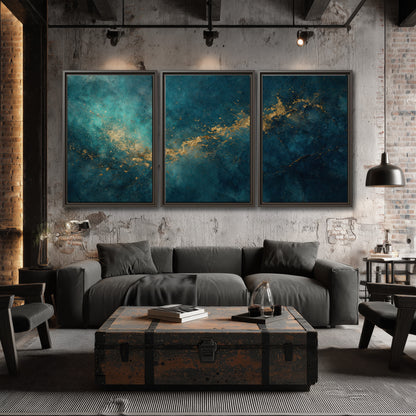 Deep teal clouds with sweeping gold-colored accents 3 piece framed canvas wall art displayed in a industrial room