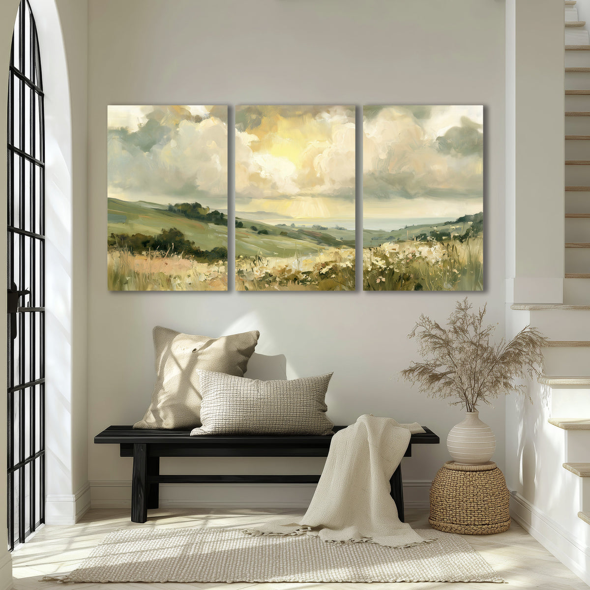 Rolling green hills beneath a luminous cloudy sky 3 piece canvas wall art displayed in a entryway