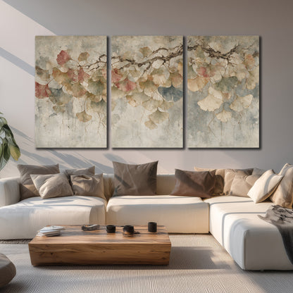 Cream and blush ginkgo leaves on delicate branches 3 piece canvas wall art displayed in a living room
