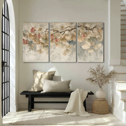Cream and blush ginkgo leaves on delicate branches 3 piece canvas wall art displayed in a entryway
