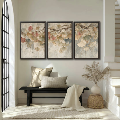 Cream and blush ginkgo leaves on delicate branches 3 piece framed canvas wall art displayed in a entryway