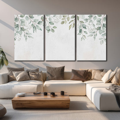 Pale sage eucalyptus leaves against a light background 3 piece canvas wall art displayed in a living room