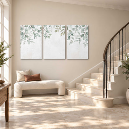 Pale sage eucalyptus leaves against a light background 3 piece canvas wall art styled in an interior