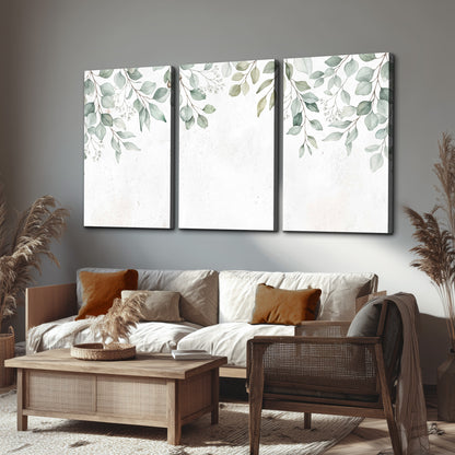 Pale sage eucalyptus leaves against a light background 3 piece canvas wall art displayed in a rustic living room