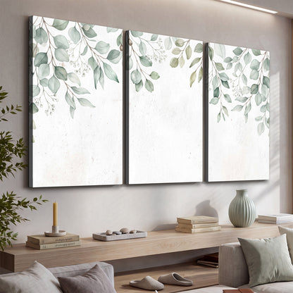 Pale sage eucalyptus leaves against a light background 3 piece canvas wall art displayed in a console