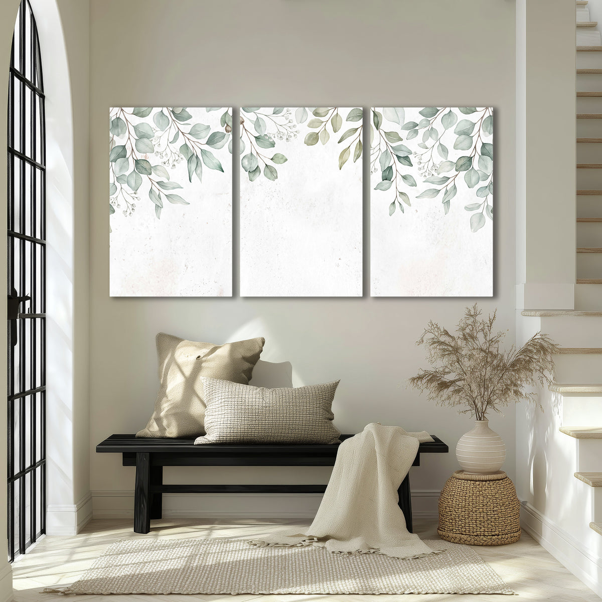 Pale sage eucalyptus leaves against a light background 3 piece canvas wall art displayed in a entryway