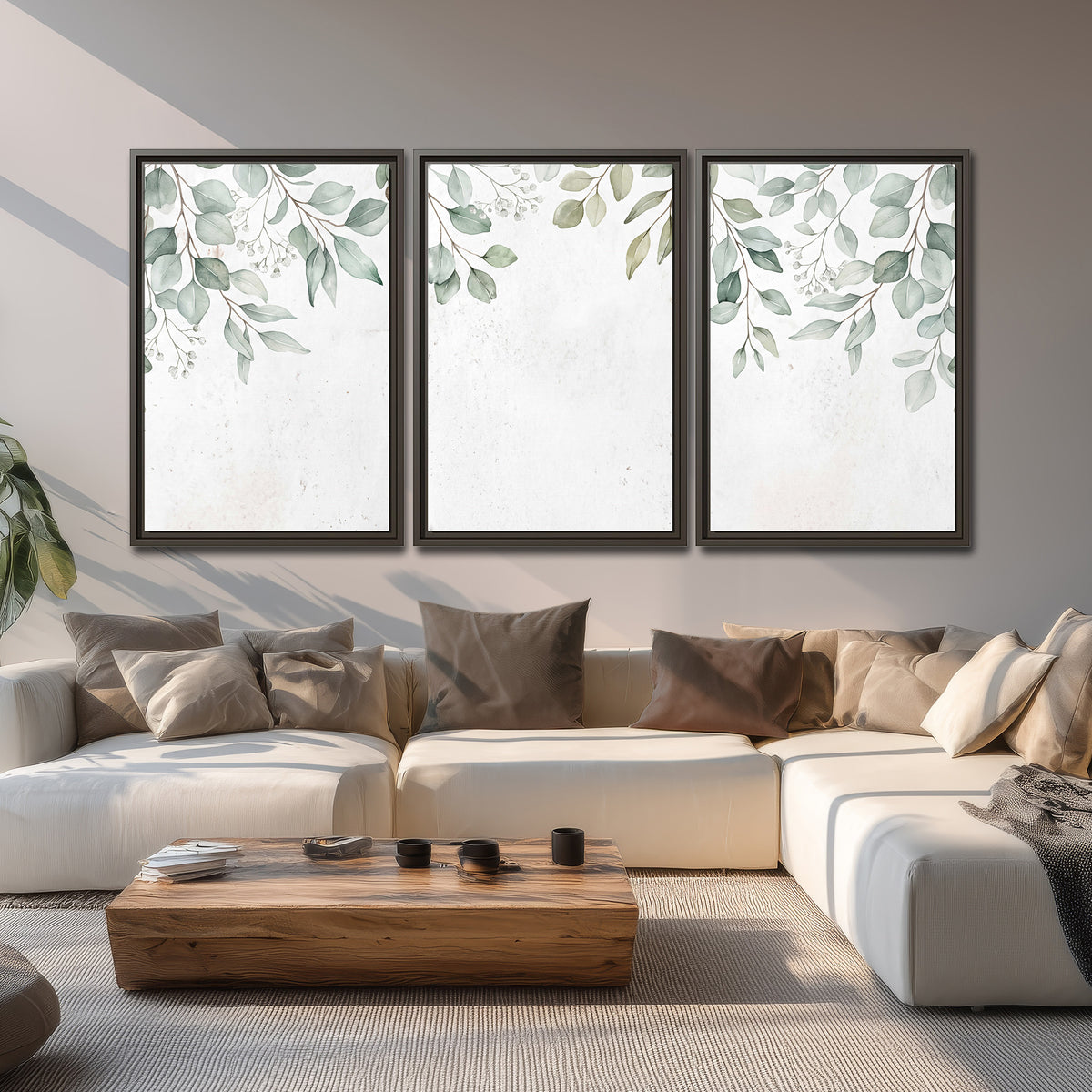 Pale sage eucalyptus leaves against a light background 3 piece framed canvas wall art displayed in a living room