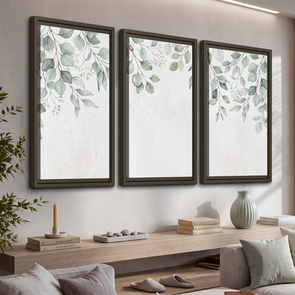 Pale sage eucalyptus leaves against a light background 3 piece framed canvas wall art displayed in a console