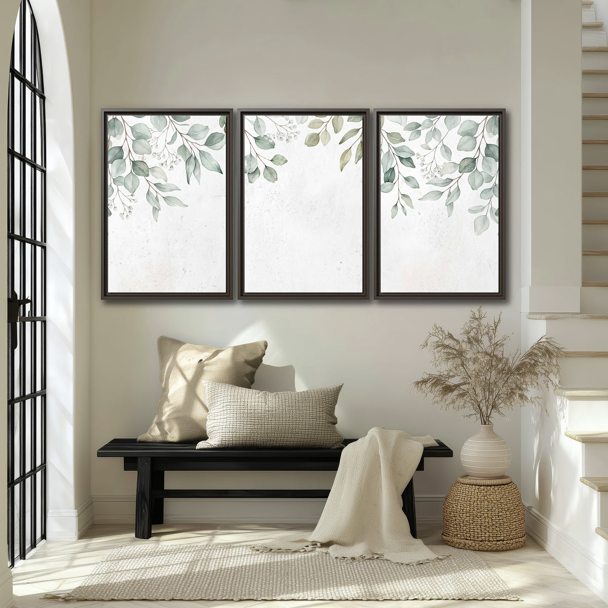 Pale sage eucalyptus leaves against a light background 3 piece framed canvas wall art displayed in a entryway