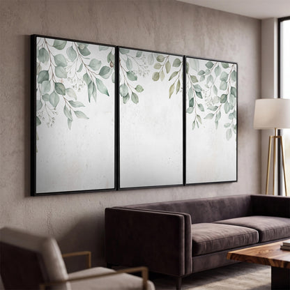 Pale sage eucalyptus leaves against a light background 3 piece framed canvas wall art displayed in a modern living room