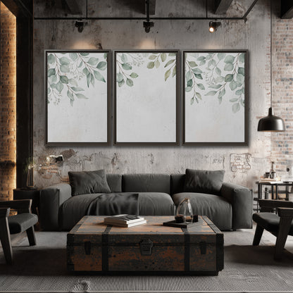 Pale sage eucalyptus leaves against a light background 3 piece framed canvas wall art displayed in a industrial room