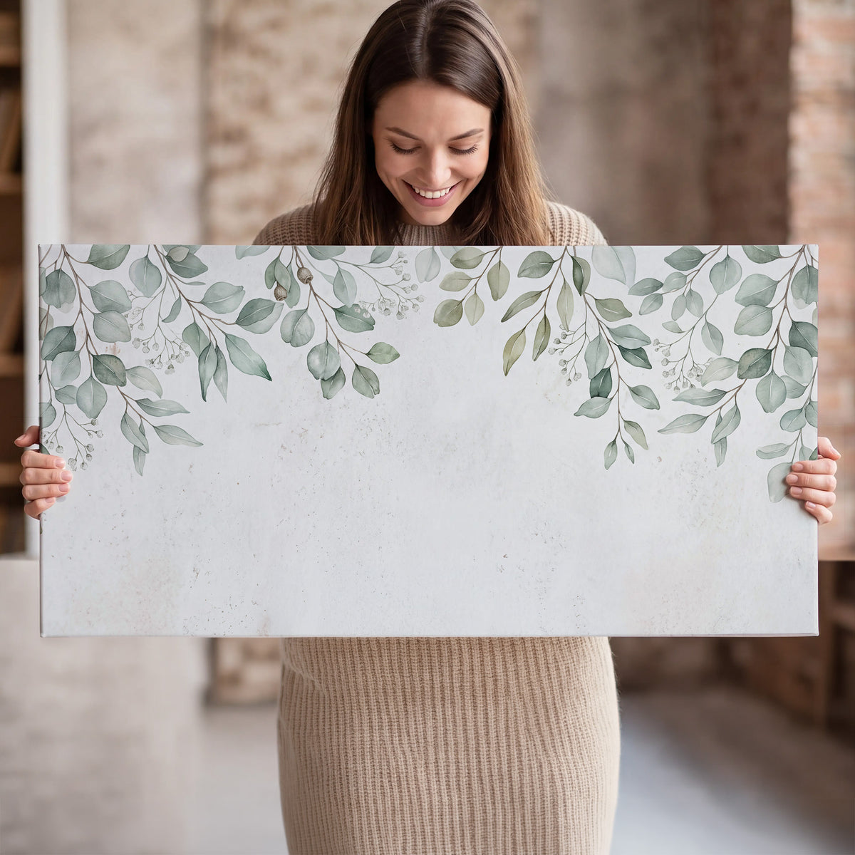 Pale sage eucalyptus leaves against a light background single canvas wall art held in hands