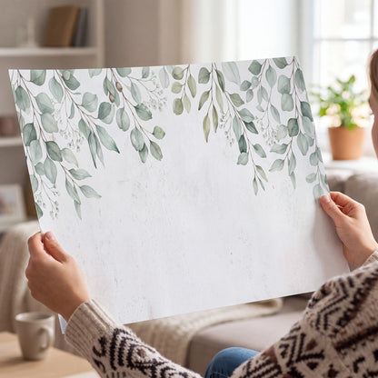 Pale sage eucalyptus leaves against a light background single poster print held in hands