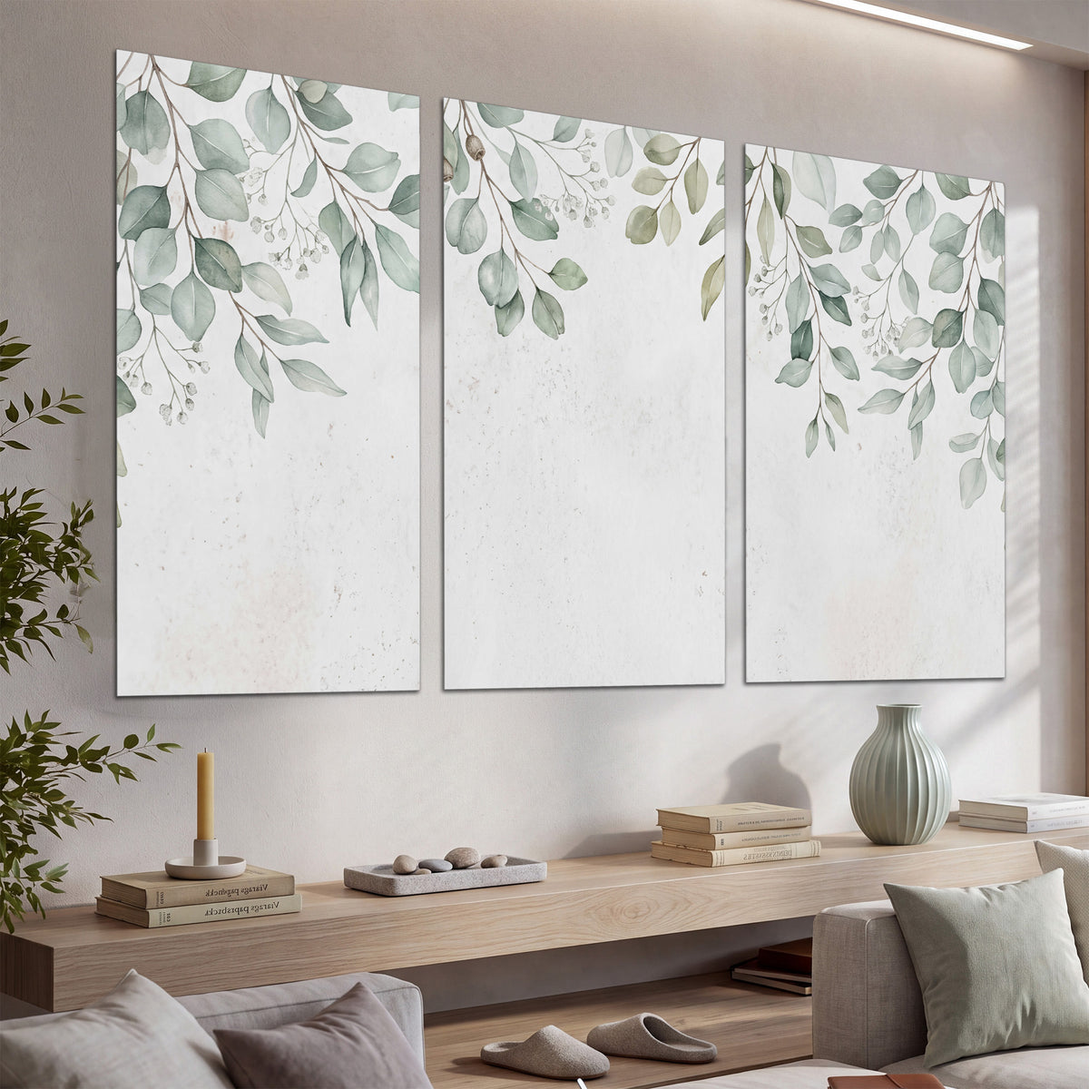 Pale sage eucalyptus leaves against a light background set of 3 poster prints displayed in a console