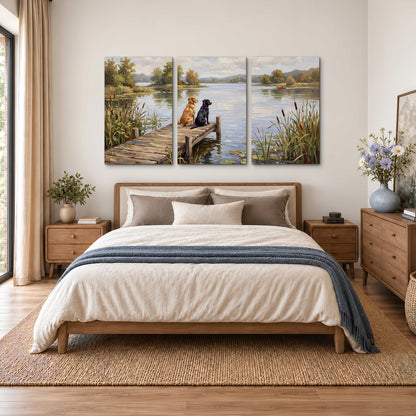 Two dogs sitting together on a wooden dock overlooking a peaceful lake 3 piece canvas wall art styled in an interior
