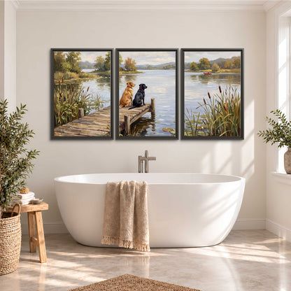 Two dogs sitting together on a wooden dock overlooking a peaceful lake 3 piece framed canvas wall art styled in an interior
