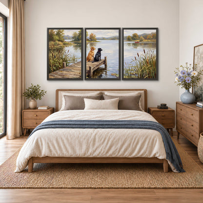 Two dogs sitting together on a wooden dock overlooking a peaceful lake 3 piece framed canvas wall art styled in an interior