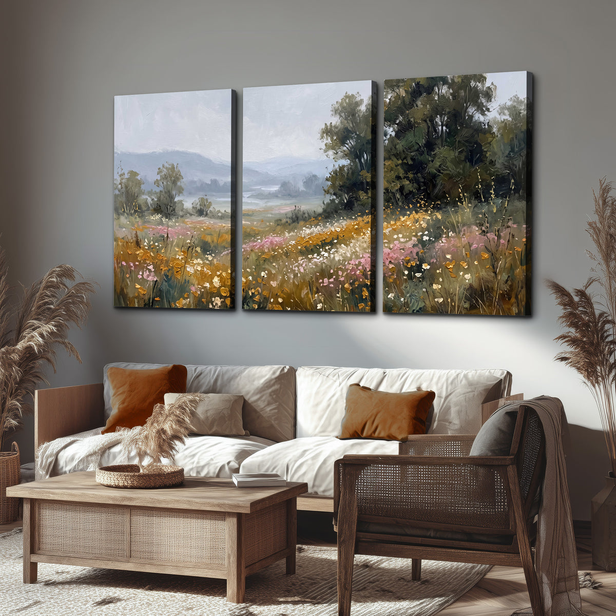 A flower-filled meadow overlooking soft blue mountain ridges 3 piece canvas wall art displayed in a rustic living room
