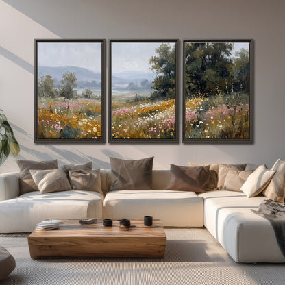 A flower-filled meadow overlooking soft blue mountain ridges 3 piece framed canvas wall art displayed in a living room