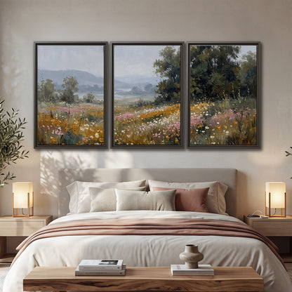 A flower-filled meadow overlooking soft blue mountain ridges 3 piece framed canvas wall art displayed in a bedroom