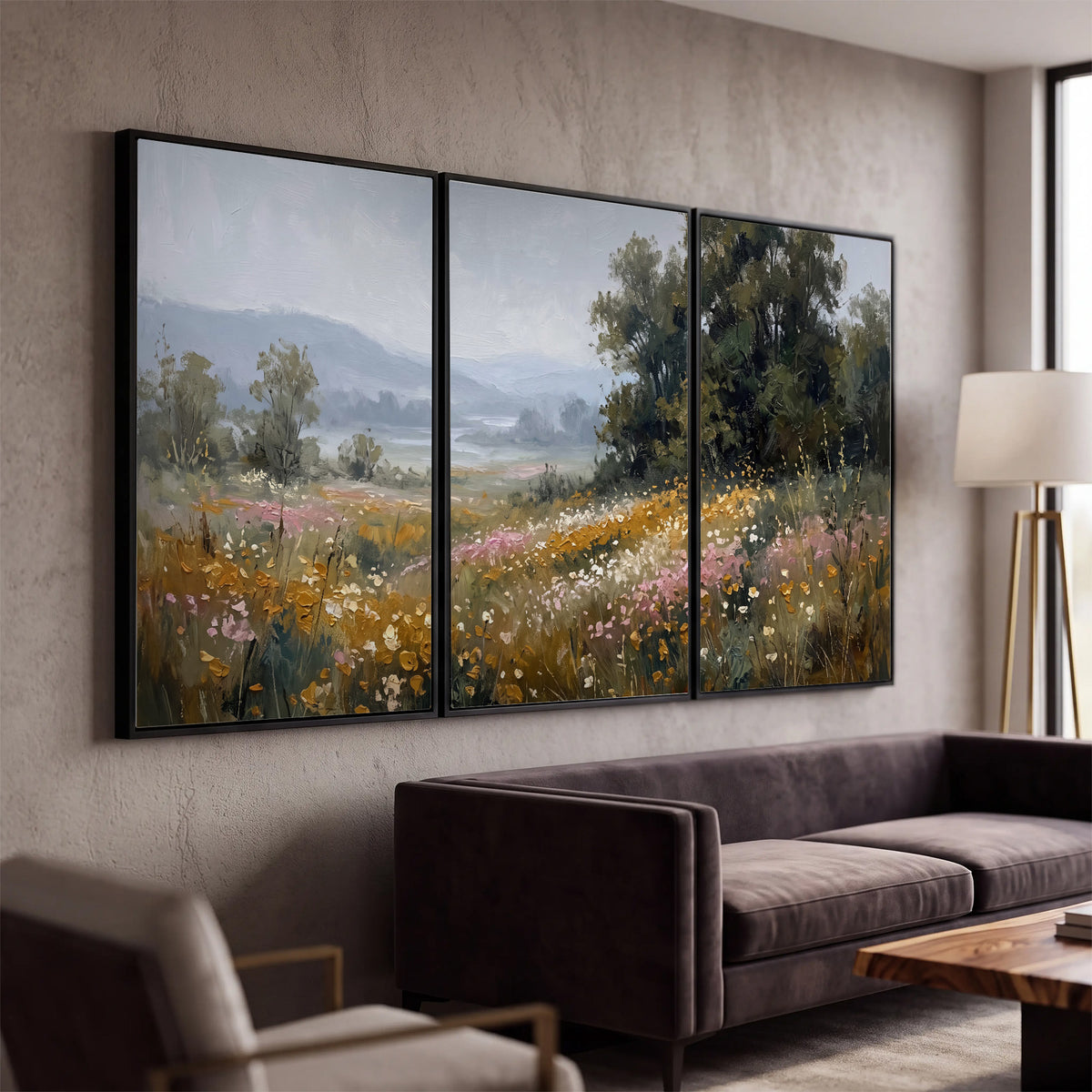 A flower-filled meadow overlooking soft blue mountain ridges 3 piece framed canvas wall art displayed in a modern living room