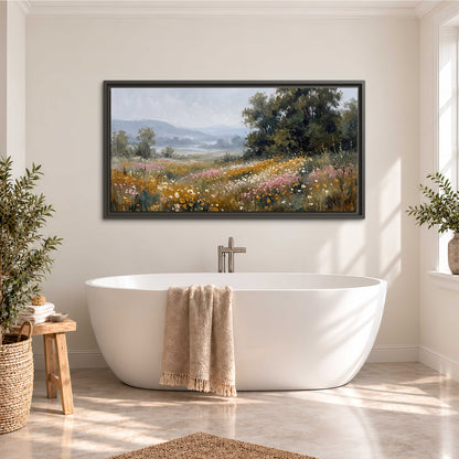 A flower-filled meadow overlooking soft blue mountain ridges single framed canvas wall art styled in an interior