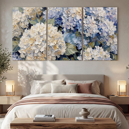 Clusters of pale blue and ivory hydrangea blossoms 3 piece canvas wall art displayed in a bedroom