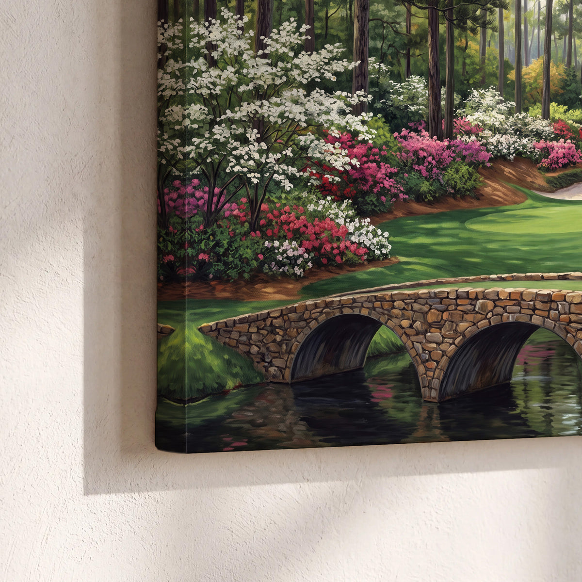 An arched stone bridge beside a landscaped golf course and reflective pond 3 piece canvas wall art material and edge close up