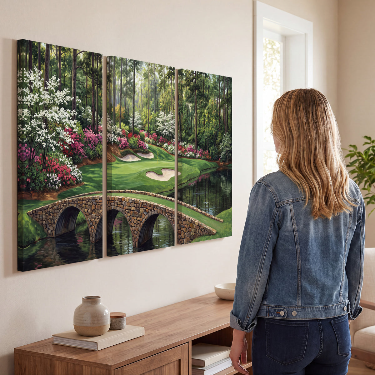 An arched stone bridge beside a landscaped golf course and reflective pond 3 piece canvas wall art three panel arrangement on a wall