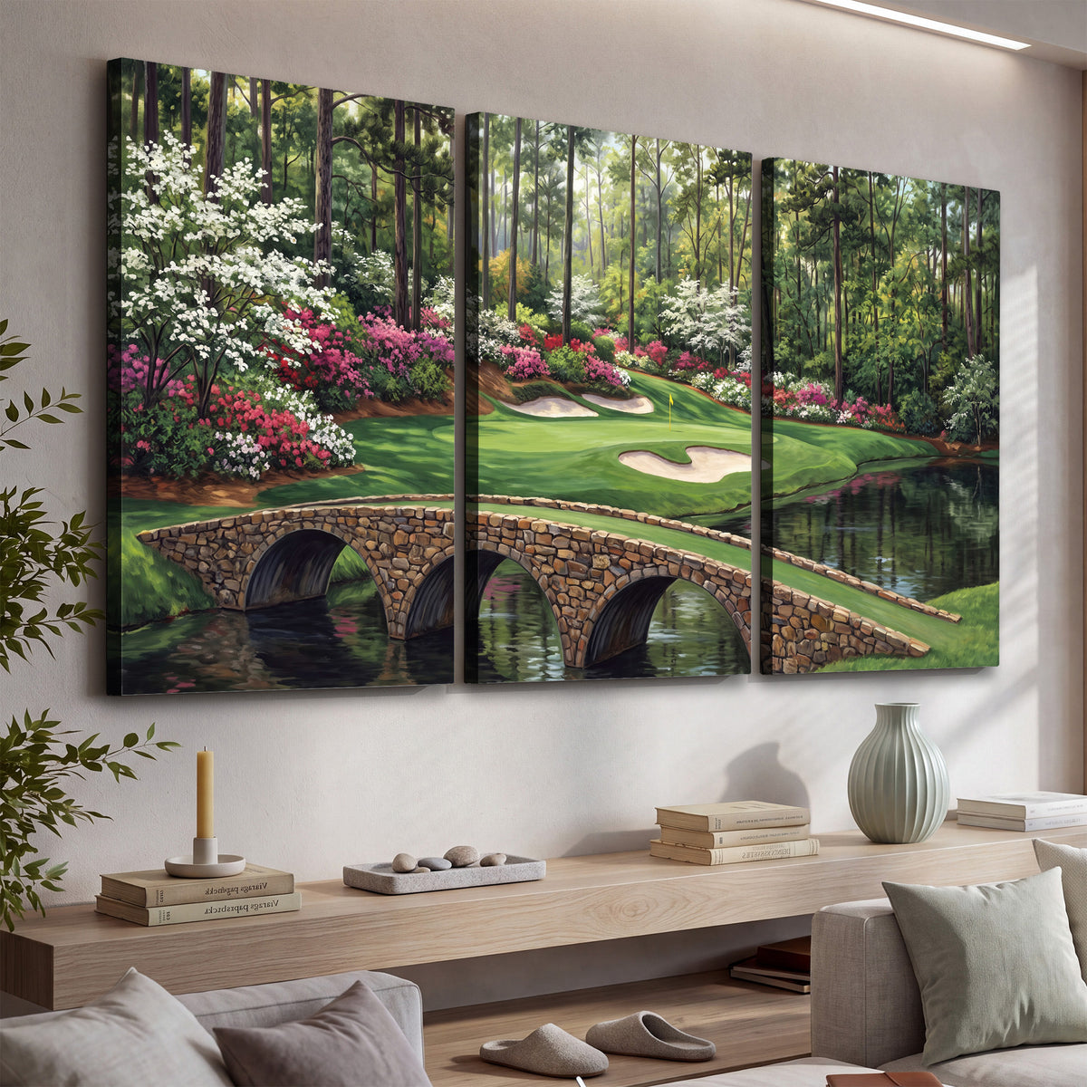 An arched stone bridge beside a landscaped golf course and reflective pond 3 piece canvas wall art displayed in a console